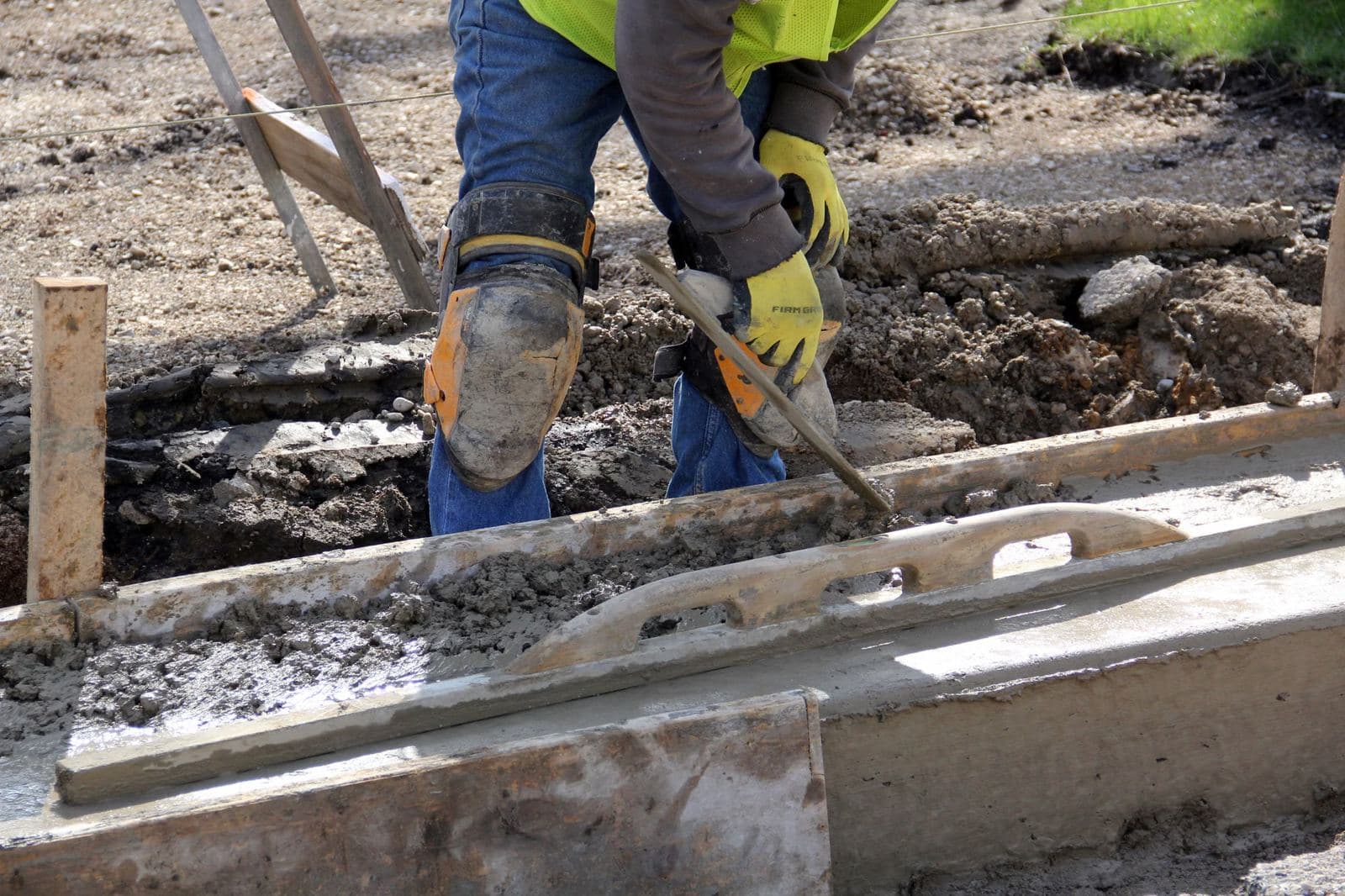 Concept photograph. A trowel on wet concrete.