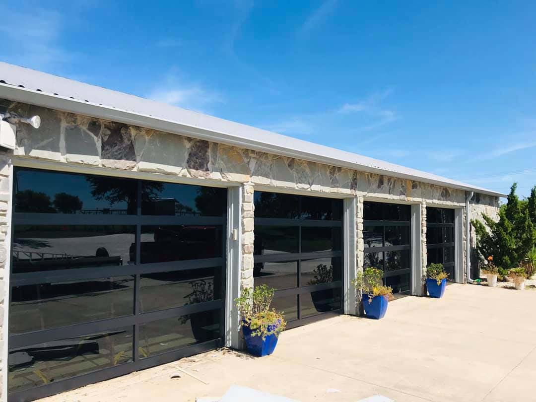 Four full-view glass garage doors.